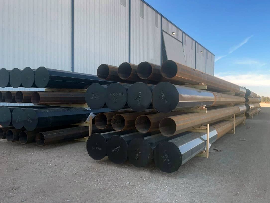 Pre-Engineered Wood Pole Equivalent Steel Poles in front of a warehouse or manufacturing facility